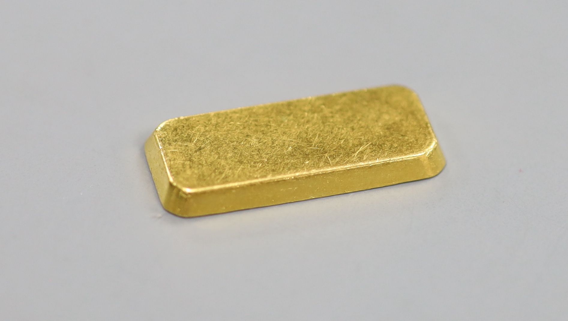 A Degussa 999.9 yellow metal 10 gram ingot.